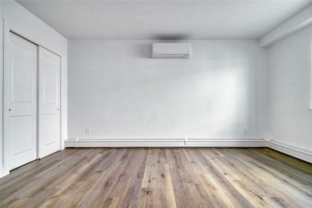 22 May Pl, Staten Island, NY 10312 - unfurnished bedroom with a wall unit AC, wood finished floors, and a closet