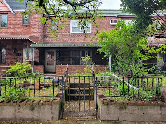 48-16 65th St, Woodside, NY 11377 - view of front of property featuring brick siding, a fenced front yard, and a gate