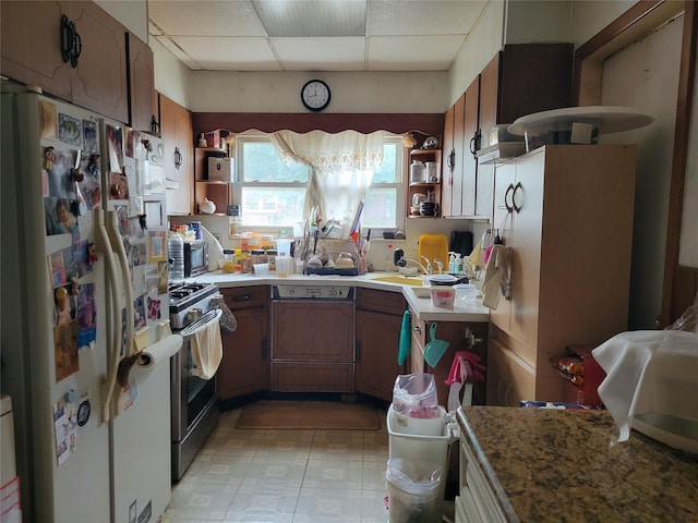 48-16 65th St, Woodside, NY 11377 - kitchen featuring freestanding refrigerator, open shelves, stainless steel range with gas stovetop, a drop ceiling, and light countertops