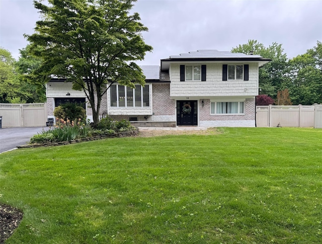 16 Graystone Dr, East Northport, NY 11731 - tri-level home with roof mounted solar panels and brick siding