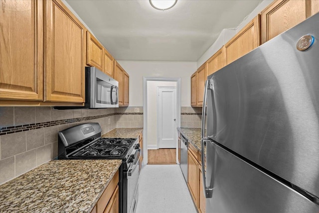 20 William St Unit B, Mount Vernon, NY 10552 - kitchen featuring appliances with stainless steel finishes, decorative backsplash, and dark stone counters