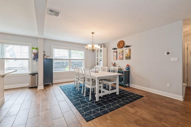 130 Shenandoah Blvd N, Nesconset, NY 11767 - dining space featuring wood finished floors, a chandelier, and baseboards