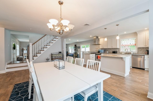 130 Shenandoah Blvd N, Nesconset, NY 11767 - dining room with stairway, light wood finished floors, a chandelier, recessed lighting, and baseboards