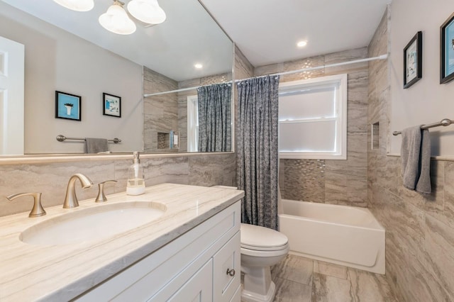 130 Shenandoah Blvd N, Nesconset, NY 11767 - bathroom featuring tile walls, shower / bath combo with shower curtain, vanity, toilet, and a chandelier