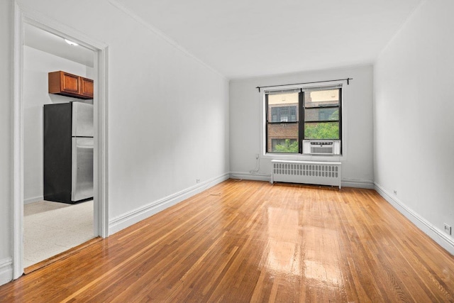 3656 Johnson Ave Unit 4G, Bronx, NY 10463 - spare room featuring radiator, light wood-style floors, baseboards, ornamental molding, and cooling unit
