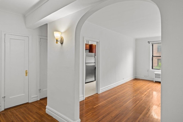 3656 Johnson Ave Unit 4G, Bronx, NY 10463 - hallway featuring arched walkways, ornamental molding, radiator, wood finished floors, and baseboards