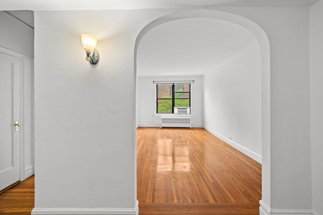 3656 Johnson Ave Unit 4G, Bronx, NY 10463 - hallway with radiator, arched walkways, wood finished floors, and baseboards