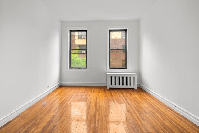 3656 Johnson Ave Unit 4G, Bronx, NY 10463 - unfurnished room featuring radiator heating unit, wood-type flooring, and baseboards