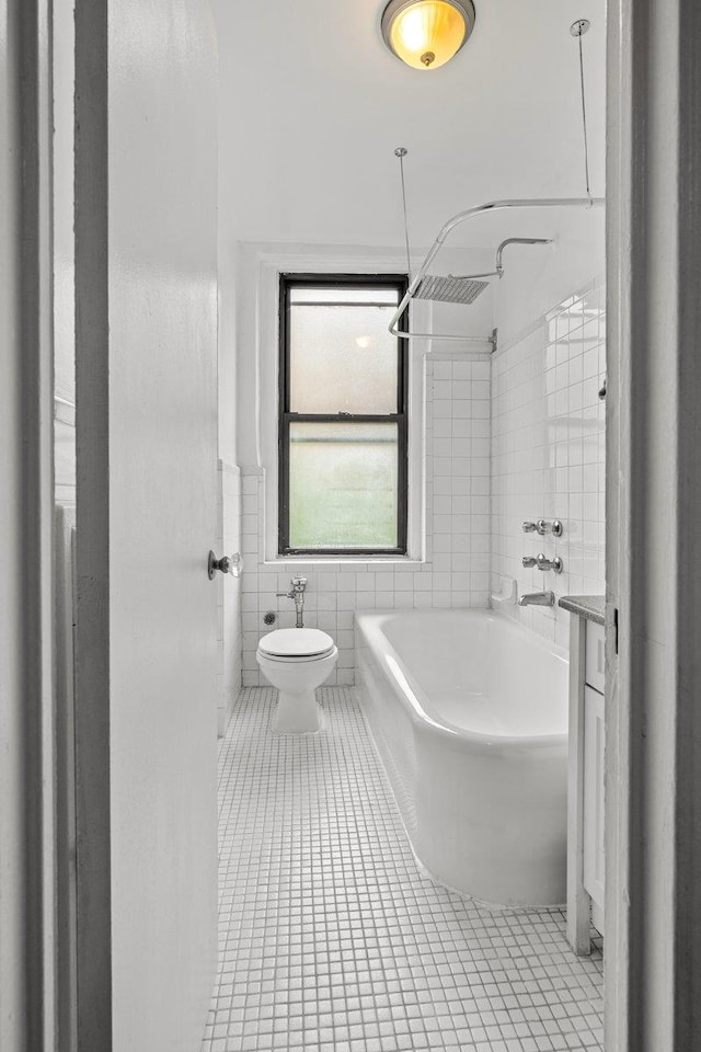 3656 Johnson Ave Unit 4G, Bronx, NY 10463 - bathroom with tile walls, tile patterned flooring, shower / bathtub combination, toilet, and wainscoting