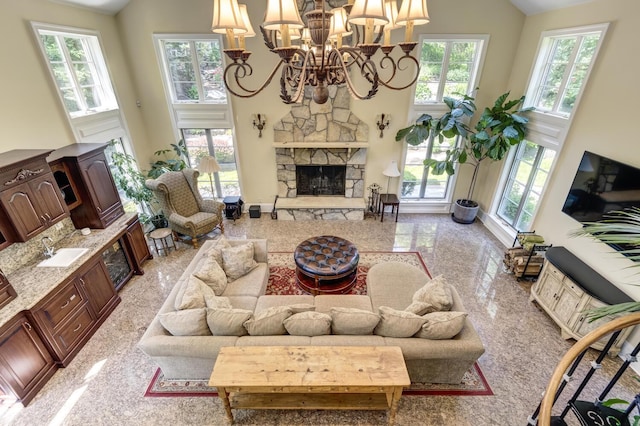 8 Chicken Valley Rd, Old Brookville, NY 11545 - living room featuring high vaulted ceiling, a fireplace, a chandelier, granite tiled floors, and baseboards