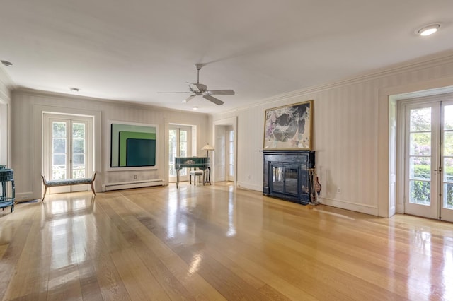 8 Chicken Valley Rd, Old Brookville, NY 11545 - unfurnished living room with baseboard heating, crown molding, plenty of natural light, wood finished floors, and a decorative wall