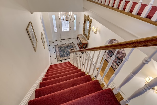 8 Chicken Valley Rd, Old Brookville, NY 11545 - staircase with a chandelier and baseboards