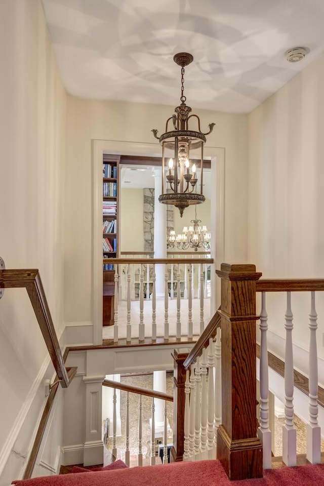 8 Chicken Valley Rd, Old Brookville, NY 11545 - stairway with a chandelier and baseboards
