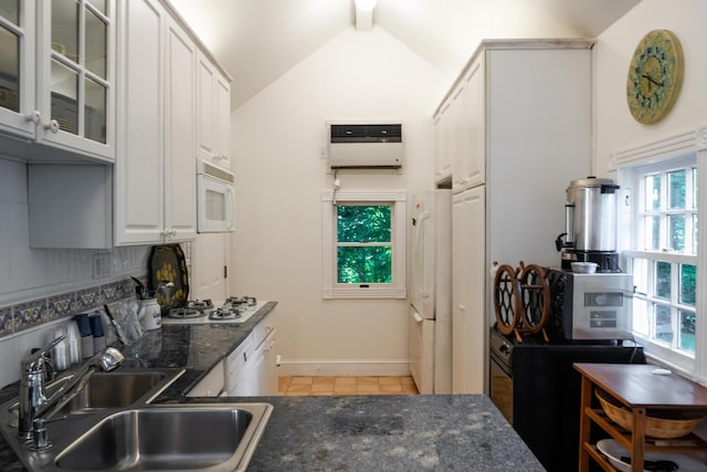 8 Chicken Valley Rd, Old Brookville, NY 11545 - kitchen with a sink, white appliances, light tile patterned floors, healthy amount of natural light, and vaulted ceiling