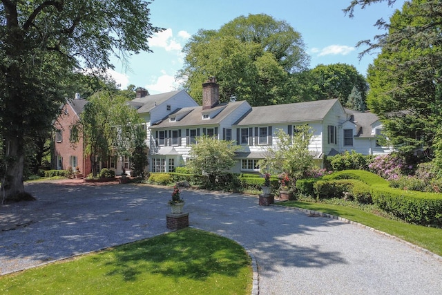 8 Chicken Valley Rd, Old Brookville, NY 11545 - view of front of house with a chimney