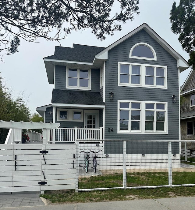 24 Bungalow Walk, Ocean Beach, NY 11770 - view of front facade featuring a fenced front yard, roof with shingles, a gate, and covered porch