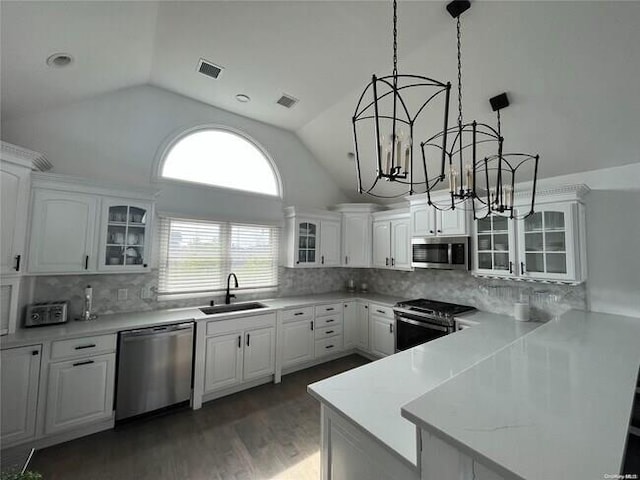 24 Bungalow Walk, Ocean Beach, NY 11770 - kitchen featuring appliances with stainless steel finishes, a sink, a chandelier, lofted ceiling, and tasteful backsplash
