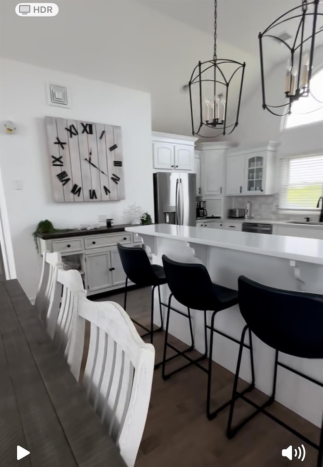 24 Bungalow Walk, Ocean Beach, NY 11770 - kitchen with stainless steel refrigerator with ice dispenser, a chandelier, a sink, and white cabinets