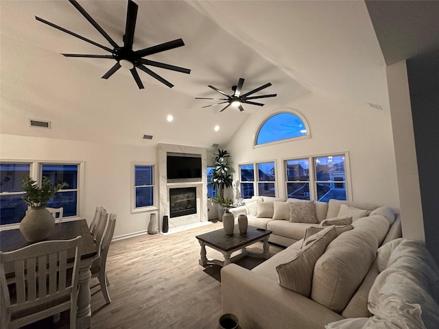 24 Bungalow Walk, Ocean Beach, NY 11770 - living area with a premium fireplace, a ceiling fan, recessed lighting, high vaulted ceiling, and wood finished floors