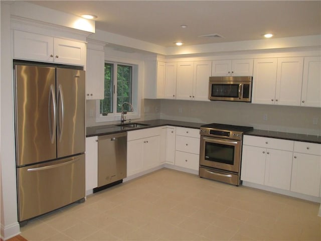 29 Carpenter Ave Unit B3, Mount Kisco, NY 10549 - kitchen with appliances with stainless steel finishes, a sink, white cabinets, dark countertops, and recessed lighting