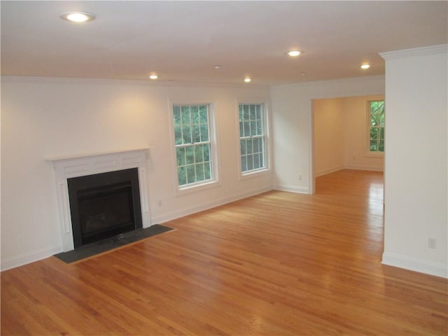 29 Carpenter Ave Unit B3, Mount Kisco, NY 10549 - unfurnished living room with ornamental molding, light wood-type flooring, baseboards, recessed lighting, and a fireplace with flush hearth