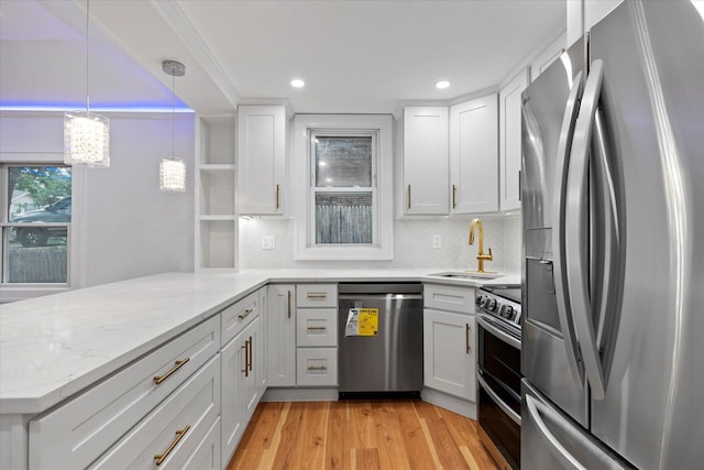 8 Lafayette Ave, Lake Grove, NY 11755 - kitchen with appliances with stainless steel finishes, a sink, a peninsula, white cabinets, and tasteful backsplash