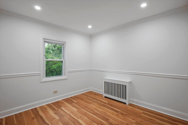 8 Lafayette Ave, Lake Grove, NY 11755 - empty room featuring radiator heating unit, ornamental molding, baseboards, light wood finished floors, and recessed lighting