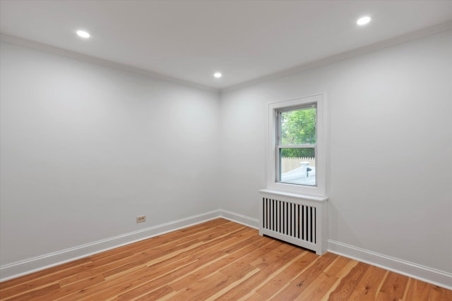 8 Lafayette Ave, Lake Grove, NY 11755 - spare room with radiator, ornamental molding, light wood-style flooring, baseboards, and recessed lighting