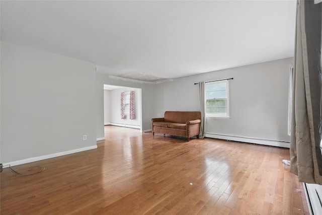 1668 Rte 9 Unit 10D, Wappingers Falls, NY 12590 - unfurnished room featuring a baseboard heating unit, wood finished floors, and baseboards