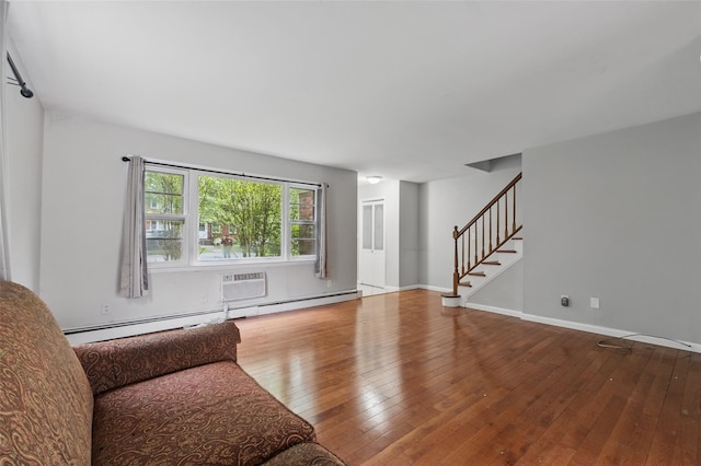1668 Rte 9 Unit 10D, Wappingers Falls, NY 12590 - living room featuring stairway, hardwood / wood-style floors, baseboard heating, an AC wall unit, and baseboards