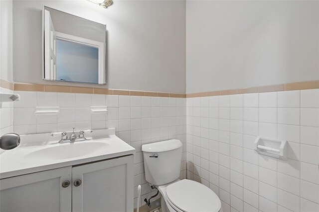 1668 Rte 9 Unit 10D, Wappingers Falls, NY 12590 - bathroom featuring toilet, vanity, tile walls, and a wainscoted wall