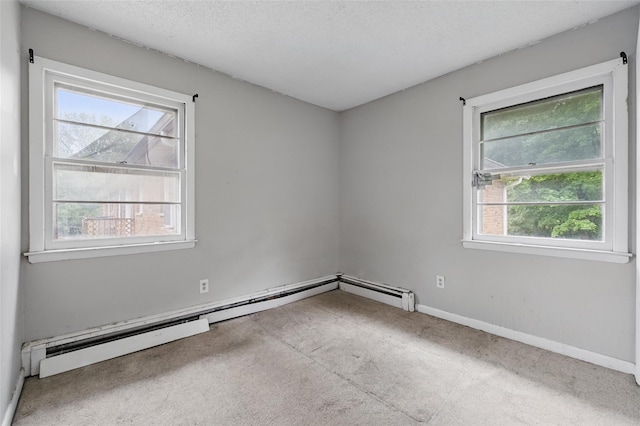 1668 Rte 9 Unit 10D, Wappingers Falls, NY 12590 - empty room with carpet flooring, a baseboard radiator, baseboards, and a textured ceiling