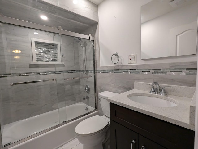 1114 Arden Ave, Staten Island, NY 10312 - bathroom featuring toilet, combined bath / shower with glass door, vanity, and tile walls