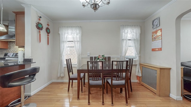 68-37 Kessel St, Forest Hills, NY 11375 - dining space with arched walkways, light wood-style flooring, ornamental molding, baseboards, and a chandelier