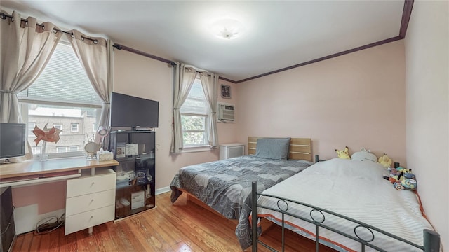 68-37 Kessel St, Forest Hills, NY 11375 - bedroom with ornamental molding, wood finished floors, a wall unit AC, and baseboards