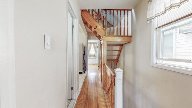 68-37 Kessel St, Forest Hills, NY 11375 - hall featuring plenty of natural light, light wood-style flooring, an upstairs landing, and baseboards