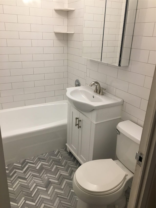70-25 Yellow Stone Blvd Unit 10Z, Forest Hills, NY 11375 - bathroom with tile walls, vanity, toilet, backsplash, and bathtub / shower combination