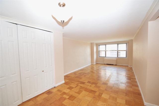 70-25 Yellow Stone Blvd Unit 10Z, Forest Hills, NY 11375 - unfurnished bedroom featuring crown molding, a closet, and radiator heating unit
