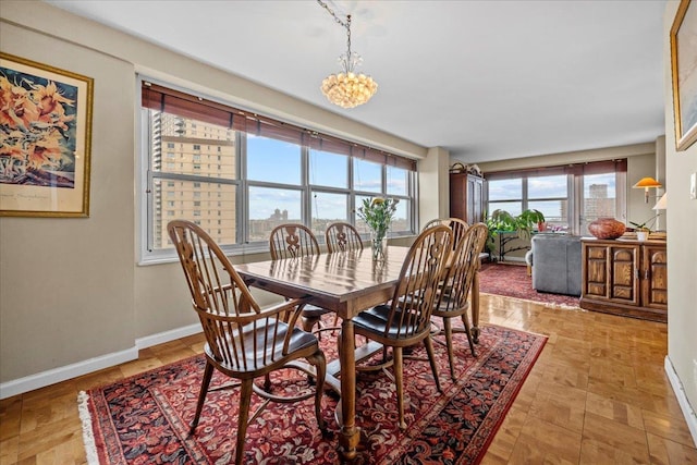 555 Kappock St Unit 17D, Bronx, NY 10463 - dining space with baseboards and a chandelier