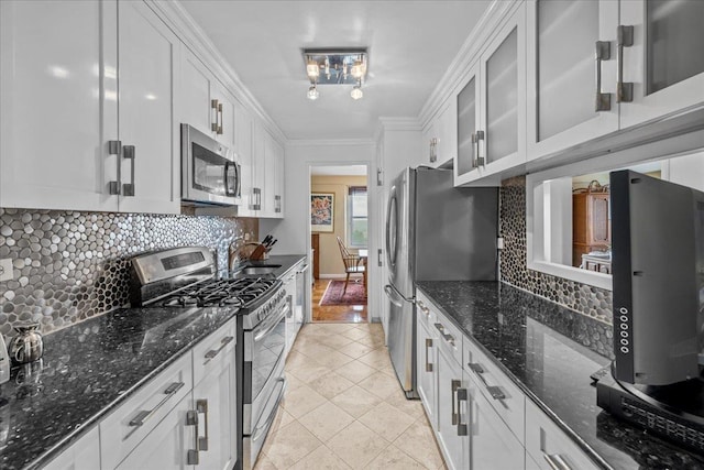 555 Kappock St Unit 17D, Bronx, NY 10463 - kitchen featuring stainless steel appliances, a sink, white cabinetry, glass insert cabinets, and tasteful backsplash