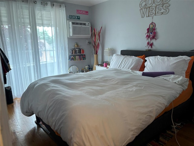 133-50 123rd St Unit 2, South Ozone Park, NY 11420 - bedroom featuring a wall unit AC and wood-type flooring