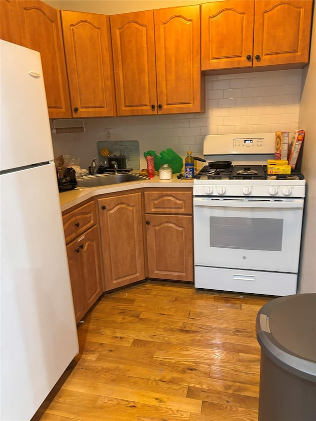 133-50 123rd St Unit 2, South Ozone Park, NY 11420 - kitchen featuring white appliances, a sink, light countertops, and light wood-style floors
