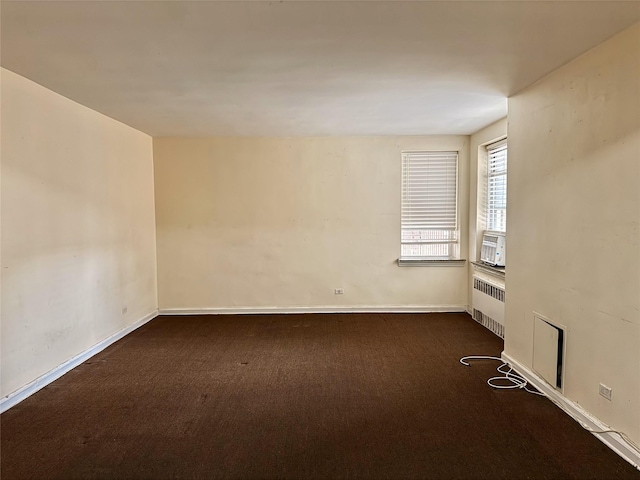 105-24 64 Unit 4L, Forest Hills, NY 11375 - empty room featuring radiator heating unit, dark carpet, and baseboards