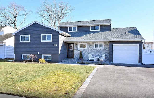 321 2nd Ave, Massapequa Park, NY 11762 - split level home with an attached garage, a front yard, asphalt driveway, and a shingled roof