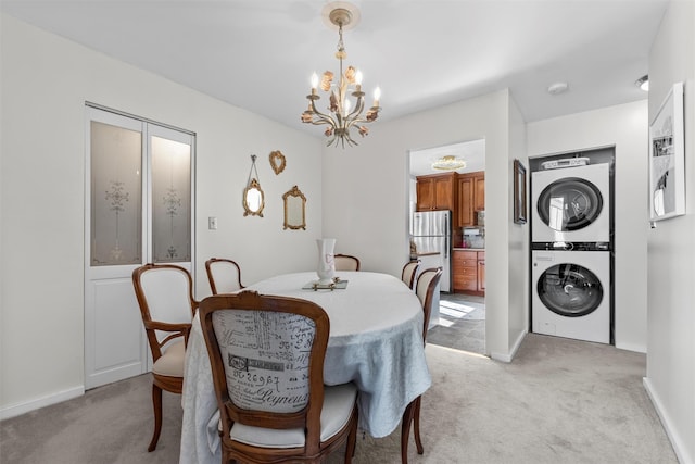 2B Kings Unit 2B, Mohegan Lake, NY 10547 - dining area with stacked washer / dryer, light carpet, and a chandelier