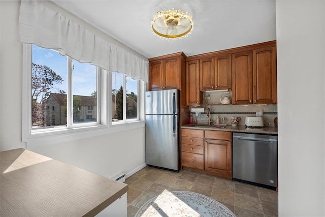 2B Kings Unit 2B, Mohegan Lake, NY 10547 - kitchen with appliances with stainless steel finishes, plenty of natural light, decorative backsplash, and brown cabinetry