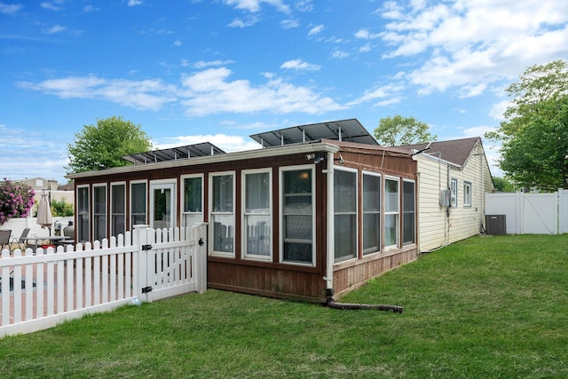 25 Biscayne Dr, Selden, NY 11784 - rear view of property featuring a gate, a sunroom, and central air condition unit