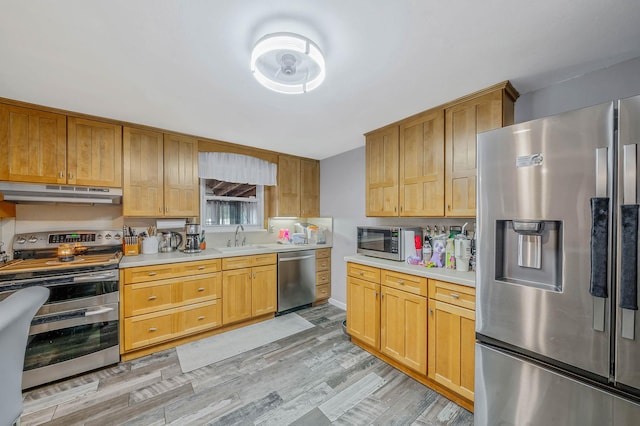 25 Biscayne Dr, Selden, NY 11784 - kitchen featuring stainless steel appliances, under cabinet range hood, a sink, light countertops, and light wood-style flooring
