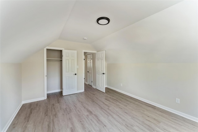 183-19 145th Ave, Springfield Gardens, NY 11413 - unfurnished bedroom featuring wood finished floors, vaulted ceiling, baseboards, and a closet