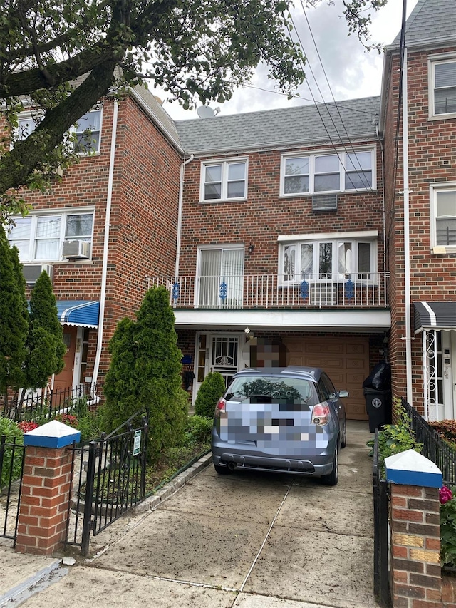56-23 137th St, Flushing, NY 11355 - view of front of home with an attached garage, brick siding, driveway, and cooling unit
